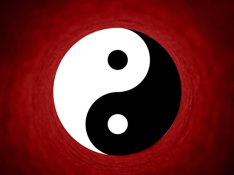 Image of a Yin Yang Symbol with a red background. 