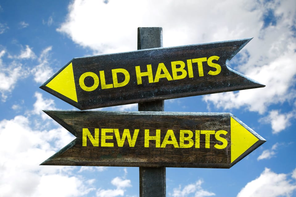 Picture of a sign with 2 arrows, one that says old habits, one that says new habits.